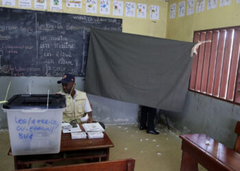 (FILES) A voter stands behind a screen as he casts his vote while an official looks on at a polling station in Libreville on October 27, 2018, in the second round of legislative elections with the party of President Ali Bongo, whose family has ruled the country for nearly 50 years, coasting towards victory. - Gabon will hold presidential, legislative and local elections in August 2023, the government of the west African country said on June 27, 2023.
A decree by the Council of Ministers announced the "convening of the electoral college for the election of the President of the Republic" plus members of the national assembly and municipal councils, on Saturday, August 26. (Photo by Steeve Jordan / AFP)