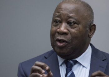 Former Ivory Coast President Laurent Gbagbo gestures as he enters the courtroom of the International Criminal Court in The Hague on January 15, 2019, where judges were expected to issue rulings on requests by Gbagbo and ex-government minister Charles Ble Goude to have their prosecutions thrown out for lack of evidence. – The International Criminal Court on January 15 acquitted former Ivory Coast president Laurent Gbagbo over post-electoral violence in the West African nation in a stunning blow to the war crimes tribunal in The Hague. Judges ordered the immediate release of the 73-year-old deposed strongman, the first head of state to stand trial at the troubled ICC, and his right-hand man Charles Ble Goude. (Photo by Peter Dejong / ANP / AFP) / Netherlands OUT