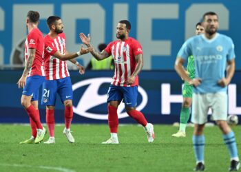 Atletico Madrid's Memphis Depay, centre, celebrates scoring his team's first goal/AFP