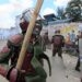 Anti-riot police officers react to the effects of tear gas after one of their canisters fired at protesters was lobbed back at them during confrontations at a mass rally called by the opposition leader Raila Odinga who claims the last Kenyan presidential election was stolen from him and blames the government for the hike of living costs in the country, in Mathare, Nairobi, on March 27, 2023. – Police fired tear gas to disperse anti-government protests on March 27, 2023 over the high cost of living, after the opposition vowed demonstrations would go ahead despite a police ban. (Photo by Tony KARUMBA / AFP)