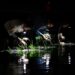 This photo taken on July 1, 2023 shows farmers planting rice on a paddy field at night-time in Hanoi. – For countless farmers in north and central Vietnam, planting in the dark has become a saviour during increasingly hot summers as South and Southeast Asia nations battle record-high temperatures this year. (Photo by Nhac NGUYEN / AFP)