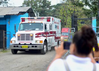 An ambulance leaves the Guayas 1 prison after clashes between inmates in Guayaquil, Ecuador, on July 23, 2023. – Ecuador, the scene of bloody prison massacres, reinforced security in its prisons this Sunday after a new confrontation between inmates in Guayaquil, without the authorities having reported victims, reported the agency in charge of managing prisons, SNAI. (Photo by Gerardo MENOSCAL / AFP)