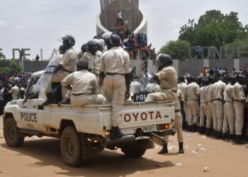 Nigerien policemen are seen as supporters rally in support of Niger’s junta in Niamey on July 30, 2023. – Thousands of people demonstrated in front of the French embassy in Niamey on Sunday, before being dispersed by tear gas, during a rally in support of the military putschists who overthrew the elected president Mohamed Bazoum in Niger. Before the tear-gas canisters were fired, a few soldiers stood in front of the embassy to calm the demonstrators. (Photo by – / AFP)