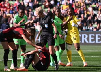 Canada’s forward Christine Sinclair reacts on the ground after missing a penalty as Nigeria’s goalkeeper Chiamaka Nnadozie (R) celebrates her save during the Australia and New Zealand 2023 Women’s World Cup Group B football match between Nigeria and Canada at Melbourne Rectangular Stadium, also known as AAMI Park, in Melbourne on July 21, 2023. (Photo by WILLIAM WEST / AFP)