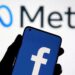 A smartphone with Facebook’s logo is seen with new rebrand logo Meta in this illustration taken October 28, 2021. REUTERS/Dado Ruvic/Illustration