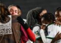 Zambia’s midfielder #06 Mary Wilombe (R) is comforted after losing again Spain in their Australia and New Zealand 2023 Women’s World Cup Group C football match at Eden Park in Auckland on July 26, 2023. (Photo by Saeed KHAN / AFP)