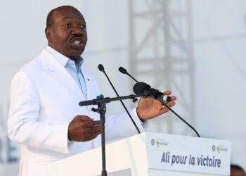 (FILES) Gabon President Ali Bongo Ondimba delivers a speech at the Nzang Ayong stadium in Libreville on July 10, 2023, a day after he announced that he would seek a third term as the oil-rich African nation’s head of state. – Gabon cut internet access and announced a nightly curfew as voting drew to a close on August 26, and opposition leader Albert Ondo Ossa denounced “fraud” in his battle for the presidency against incumbent Ali Bongo Ondimba. (Photo by Steeve JORDAN / AFP)