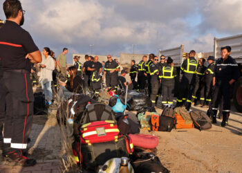 Members of the French Rescue Team gather upon arrival at al-Abraq Airport in Libya’s eastern city of al-Bayda on September 16, 2023 to assist in relief work following deadly flash floods. – A week after a wall of water rushed through the Libyan city of Derna, sweeping thousands to their deaths, the focus turned to caring for survivors of the disaster. (Photo by Karim SAHIB / AFP)