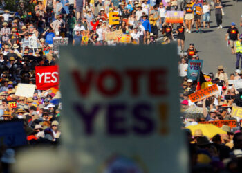 People take part in a “Walk for Yes” rally in Sydney on September 17, 2023. – Thousands joined “Walk for Yes” events in major cities, ahead of the referendum that could grant Indigenous Australians a constitutionally enshrined right to be consulted on policies that affect them — a “Voice to Parliament”. (Photo by Andrew LEESON / AFP)