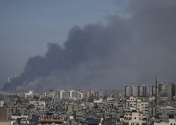 EDITORS NOTE: Graphic content / Smoke billows over the Israeli side of the border with Gaza as seen from Gaza City on October 7, 2023 following a series of early morning rocket attacks from the Gaza Strip into Israel. Palestinian militants have begun a “war” against Israel, the country’s defence minister said on October 7 after a barrage of rockets were fired and fighters from the Palestinian enclave infiltrated Israel, a major escalation in the Israeli-Palestinian conflict. (Photo by MOHAMMED ABED / AFP)