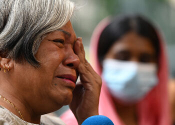 Halinda Binte Ismail, mother of death row convict Mohd Idzwan, reacts while speaking to reporters in Singapore on October 9, 2023. – Families of death row convicts urged the Singapore government on October 9 to impose a moratorium on capital punishment to allow for an independent review of the controversial use of executions in the city-state. (Photo by ROSLAN RAHMAN / AFP)