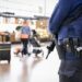 A policeman stands guard in the departure hall of Brussels Airport, in Zaventem on October 17, 2023, after the suspected perpetrator of the attack in Brussels was shot dead during a police intervention. - The suspect in the Brussels killing of two Swedish football fans was shot and fatally wounded by police during his arrest on October 17, 2023, officials said. (Photo by DIRK WAEM / BELGA / AFP) / Belgium OUT / BELGIUM OUT