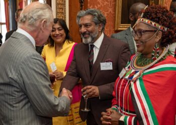 Britain’s King Charles III (L) speaks with film director Gurinda Chadha (L), actor Nitan Ganatra, and Islington and Dagenham councillor Elizabeth Kangethe, during a reception for Kenyan diaspora in the United Kingdom, at Buckingham Palace, in London, on October 24, 2023 ahead of their Majesties State Visit to Kenya. (Photo by Aaron Chown / POOL / AFP)