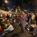 Demonstrators watch the CONCACAF Nations League group A football match between Trinidad and Tobago and Guatemala while blocking a road during a protest demanding the resignation of Attorney General Consuelo Porras and prosecutor Rafael Curruchiche in Guatemala City on October 13, 2023. – Guatemalan indigenous leaders announced Thursday that they will maintain road blockades to demand the resignation of the attorney general, whom they accuse of persecution against President-elect Bernardo Arévalo, after a meeting with President Alejandro Giammattei and OAS delegates failed. (Photo by Johan ORDONEZ / AFP)