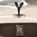 A picture shows the emblem on the bonnet of a Rolls-Royce Wraith Black Badge (R) car in a showroom in central London on January 9, 2019. Rolls-Royce announced its highest ever annual sales with 4,107 cars delivered to customers in over 50 countries around the world in 2018, on January 10, 2019. Ben STANSALL / AFP