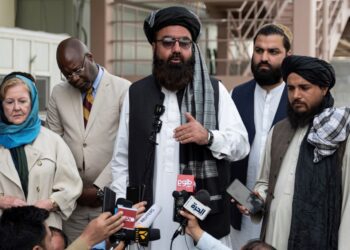 The Taliban government’s deputy minister for refugees Mohammad Arsala Kharoti (C) speaks to the media as the United Nations assistant secretary-general and assistant high commissioner for protection (UNHCR) Gillian Triggs (L) watches at the airport in Kabul on April 30, 2023. (Photo by Wakil KOHSAR / AFP)