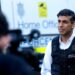 Britain’s Prime Minister Rishi Sunak speaks to the press alongside an immigration van at Wembley Police Station in northwest London on June 15, 2023. (Photo by SUSANNAH IRELAND / POOL / AFP)