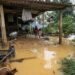 Children stand outside a house next to flood waters in Huong Khe district in central Vietnam’s Ha Tinh province on October 31, 2023. – Three people died after days of heavy rain in central and north Vietnam that flooded homes and submerged roads, disaster management authorities said October 31. (Photo by Ha Linh / AFP)