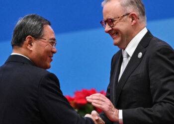 China's Premier Li Qiang (L) and Australia's Prime Minister Anthony Albanese shake hands during the opening ceremony of the 6th China International Import Expo (CIIE) in Shanghai on November 5, 2023. (Photo by Hector RETAMAL / AFP)