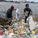 (FILES) Residents collect plastics bottles and bags in the Ebrie Lagoon in Abidjan on May 31, 2023 ahead of World environnement Day celebrations. – The latest negotiations towards a global treaty to combat plastic pollution open in Nairobi on November 13, 2023 with tensions expected as nations tussle over what should be included in the pact.Some 175 countries agreed last year to conclude by 2024 a UN treaty to combat the plastic blighting oceans, floating in the atmosphere and infiltrating the bodies of animals and humans. (Photo by Issouf SANOGO / AFP)