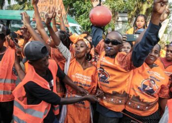 Supporters of incumbent Madagascar President Andry Rajoelina, candidate in the 2023 presidential election, greet him during his re-election campaign, in Toamasina, November 11, 2023. (Photo by RIJASOLO / AFP)