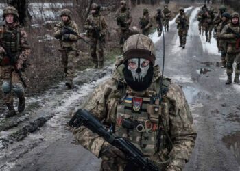 — AFP PICTURES OF THE YEAR 2023 — Ukrainian servicemen walk on the road toward their base near the frontline in the Donetsk region on February 4, 2023, amid the Russian invasion of Ukraine. (Photo by YASUYOSHI CHIBA / AFP)