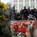 People place flowers and candles at a makeshift memorial for the victims outside the Charles University in central Prague, on December 22, 2023, as police investigators kept working on the campus the day after a deadly mass shooting. – Czech police said the December 21, 2023 shooting at Prague’s Charles University left 14 dead and 25 wounded, revising down a previously announced toll of more than 15 victims.”At this moment I can confirm 14 victims of the horrible crime and 25 wounded, of which 10 seriously,” police chief Martin Vondrasek told reporters. (Photo by Michal CIZEK / AFP)