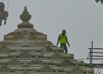 A worker is pictured at the construction site of a temple to Hindu deity Ram, in Ayodhya on December 29, 2023. – In an Indian town known as a flashpoint for sectarian violence, workers are crafting the final touches on a divisive temple that has come to symbolise the country’s rising tide of Hindu nationalism. (Photo by Arun SANKAR / AFP)