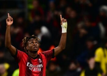 AC Milan’s Nigerian midfielder Samuel Chukwueze celebrates after scoring the team’s first goal during the UEFA Champions League Group F football match between AC Milan and Borussia Dortmund at the San Siro stadium in Milan on November 28, 2023. (Photo by AFP)