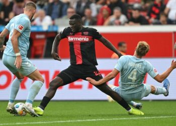 Victor Boniface tussles for the ball in Leverkusen’s 3-0 win over Cologne on October 8, 2023. (Photo by AFP)