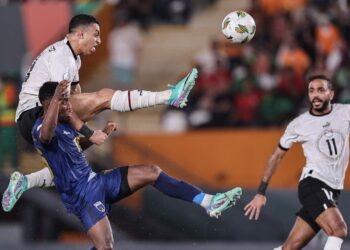 Egypt’s forward #19 Mostafa Mohamed (UP) kicks to score his team’s second goal during the Africa Cup of Nations (CAN) 2024 group B football match between Cape Verde and Egypt at the Felix Houphouet-Boigny Stadium in Abidjan on January 22, 2024. (Photo by FRANCK FIFE / AFP)