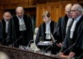 President Joan Donoghue (C), and other judges in the International Court of Justice (ICJ) take their seats prior to the hearing on the genocide case against Israel, brought by South Africa, in The Hague on January 11, 2024. – South Africa hopes that a landmark “genocide” case against Israel at the UN’s top court on Januray 11, will seek to compel Israel to halt its military operations in Gaza, where more than 23,000 Palestinians have been killed according to the Hamas-run Gaza health ministry. (Photo by Remko de Waal / ANP / AFP) / Netherlands OUT / NETHERLANDS OUT