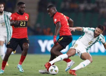 Algeria’s forward #8 Youcef Belaili fights for the ball Angola’s defender #3 Jonathan Buatu during the Africa Cup of Nations (CAN) 2024 group D football match between Algeria and Angola at Stade de la Paix in Bouake on January 15, 2024. (Photo by KENZO TRIBOUILLARD / AFP)