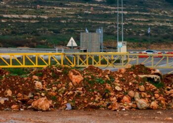 A metal barrier as well as a pile of rocks and earth placed by Israeli troops, block the northern entrance to Ramallah, on a road linking the occupied West Bank city to Nablus and other areas, on February 6, 2024. – The number of checkpoints and other barriers in the Palestinian territory has greatly increased since war broke out between Israel and militant group Hamas four months ago in Gaza, adding hours to already lengthy commutes and forcing residents to either wait at the checkpoints or take long detours. (Photo by Jaafar ASHTIYEH / AFP)