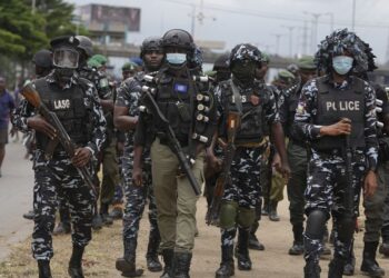 Police officers patrol during a protest against the economic hardship. on the street in Lagos, Nigeria, Friday, Aug 2, 2024.